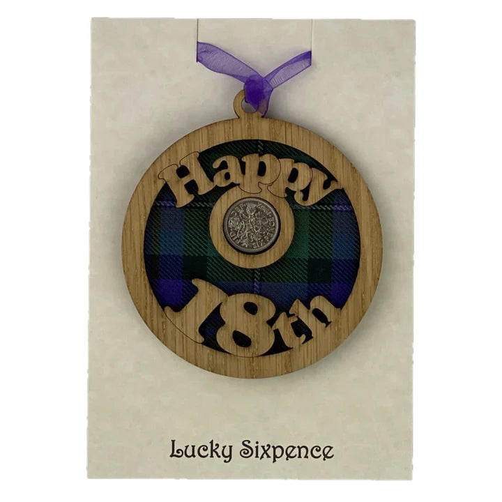 Keepsake gift with a Scottish twist.  The sixpence is mounted onto a round hanging oak veneered wood with tartan inserts, mounted on card and packaged in clear cellophane packets.   'Happy 18th' is cut into the wooden hanging.