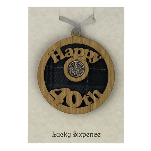 A unique keepsake gift with a Scottish twist.  The sixpence is mounted onto a round hanging oak veneered wood with tartan inserts, mounted on card and packaged in clear cellophane packets.  'Happy 40th' is cut into the wooden hanging.