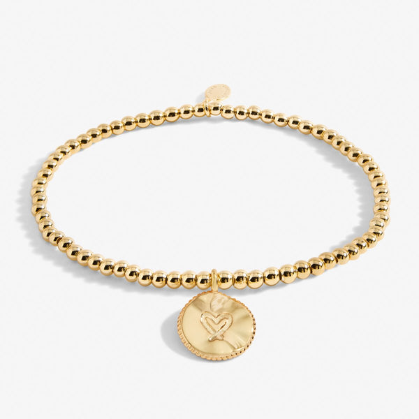 Gold plated joma stretch beaded bracelet with hanging disc charm