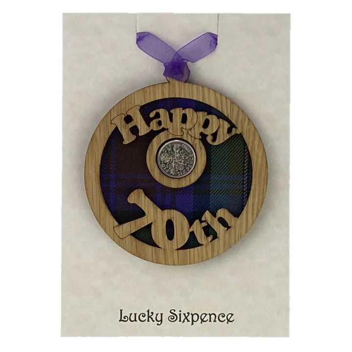 A unique keepsake gift with a Scottish twist.  The sixpence is mounted onto a round hanging oak veneered wood with tartan inserts, mounted on card and packaged in clear cellophane packets.  'Happy 70th' is cut into the wooden hanging.