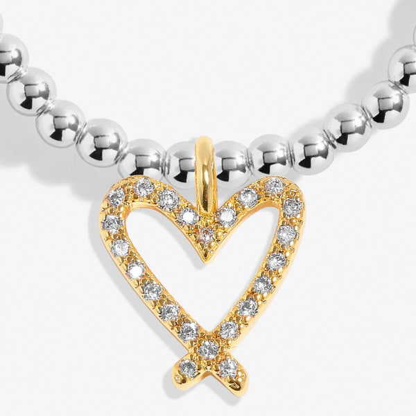 Joma beaded stretch bracelet with gold plated hanging heart charm