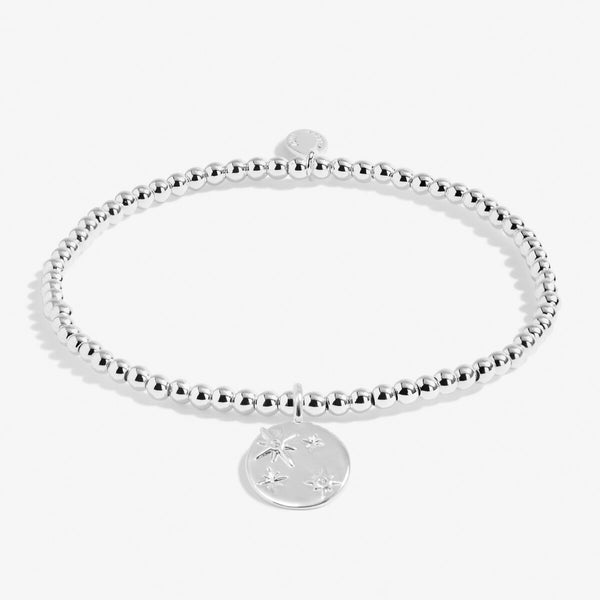 Joma stretch beaded bracelet with star engraved disc charm