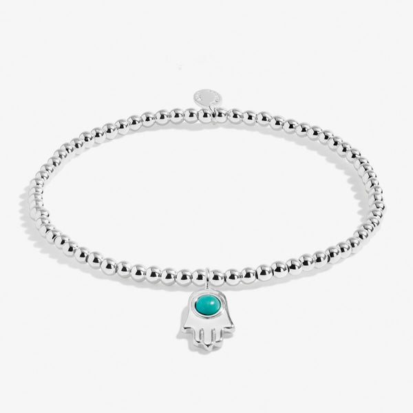 Joma jewellery a little protection bracelet with silver plated beads and a hand shaped charm with natural semi precious gemstone.