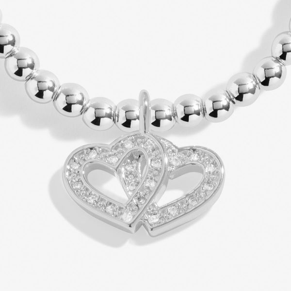 Joma jewellery silver plated beaded bracelet with hanging double heart charm with sparkle detail.