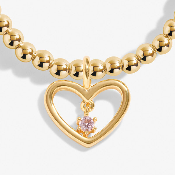 Joma jewellery gold plated beaded bracelet with open hanging heart charm and crystal detail.