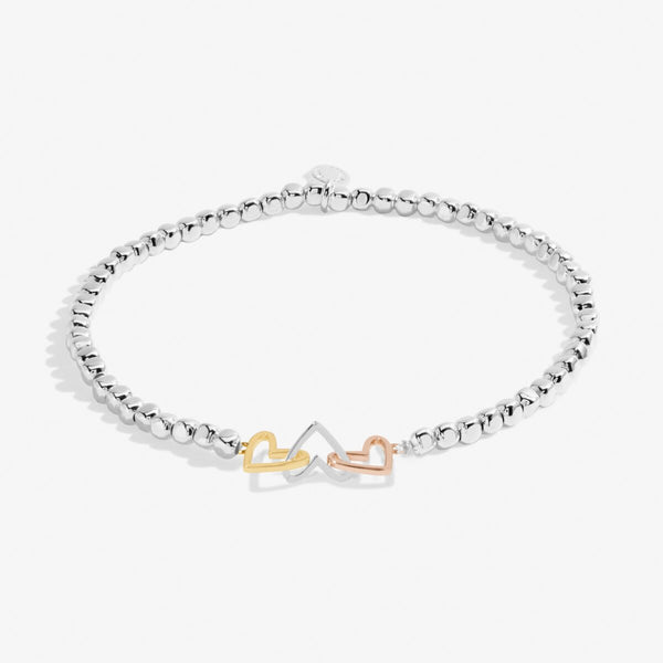 Joma Jewellery silver plated beaded bracelet with three interlinked hearts in silver, gold and rose gold.