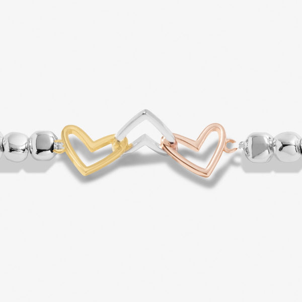 Joma Jewellery silver plated beaded bracelet with three interlinked hearts in silver, gold and rose gold.