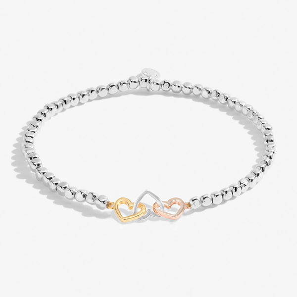 Joma Jewellery stretch beaded bracelet with interlinked heart charms in silver, gold and rose gold 