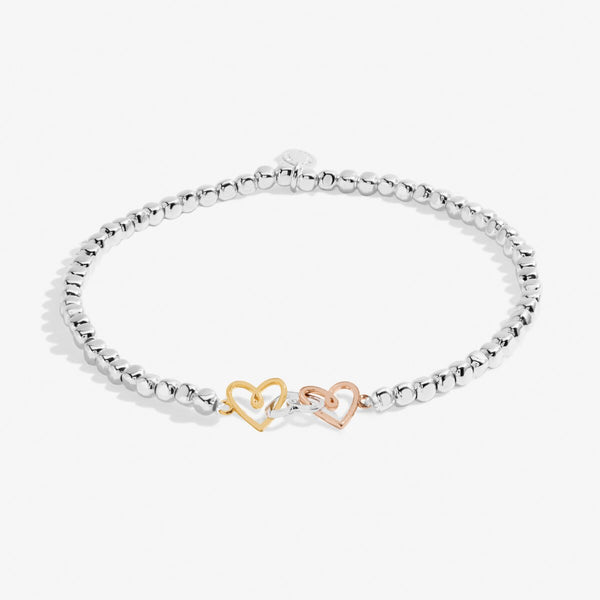 Joma jewellery stretch beaded bracelet with joined hearts in silver, gold and rose gold.