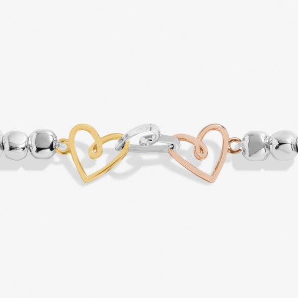 Joma jewellery stretch beaded bracelet with joined hearts in silver, gold and rose gold.