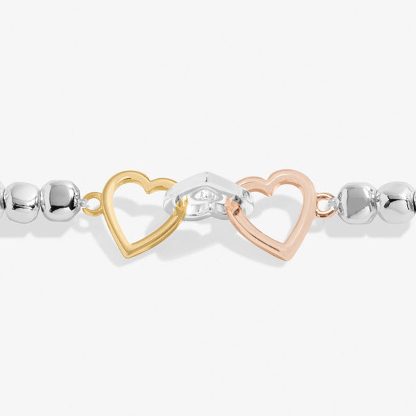 Joma jewellery stretch beaded bracelet with joined hearts in silver, gold and rose gold.