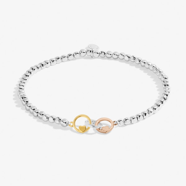 Joma jewellery beaded stretch bracelet with adjoined circle charms in silver, gold and rose gold with heart detailing.