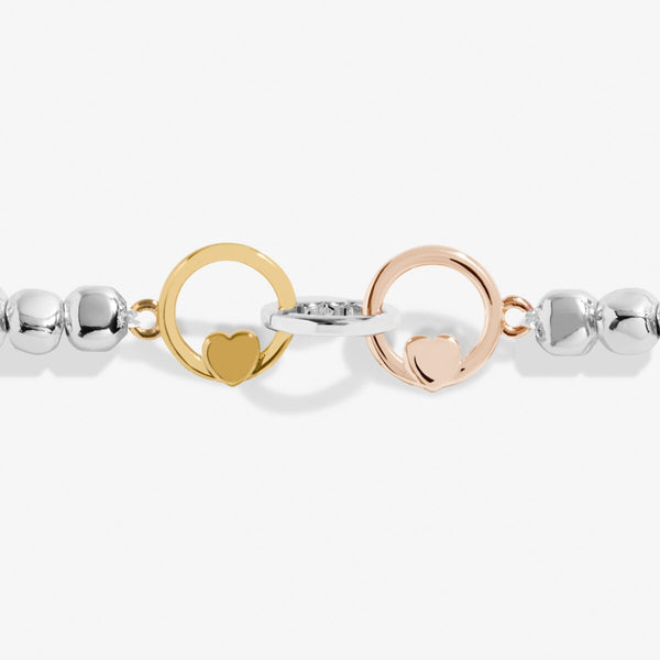 Joma jewellery beaded stretch bracelet with adjoined circle charms in silver, gold and rose gold with heart detailing.