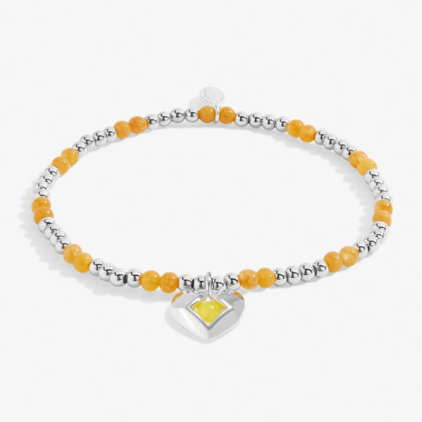 Joma Jewellery silver plated beaded bracelet with semi-precious gemstones and a silver plated hanging heart charm.