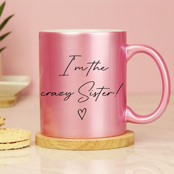 Personalised pink glitter mug with black wording and heart detail.