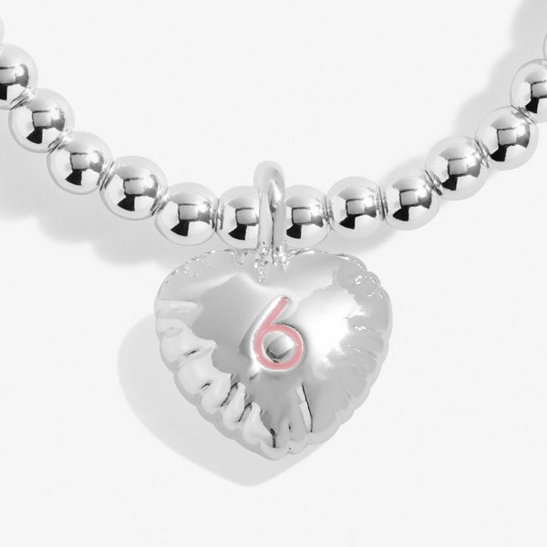 Joma jewellery silver plated girls birthday bracelet with hanging heart charm with 6 stamped in pink.