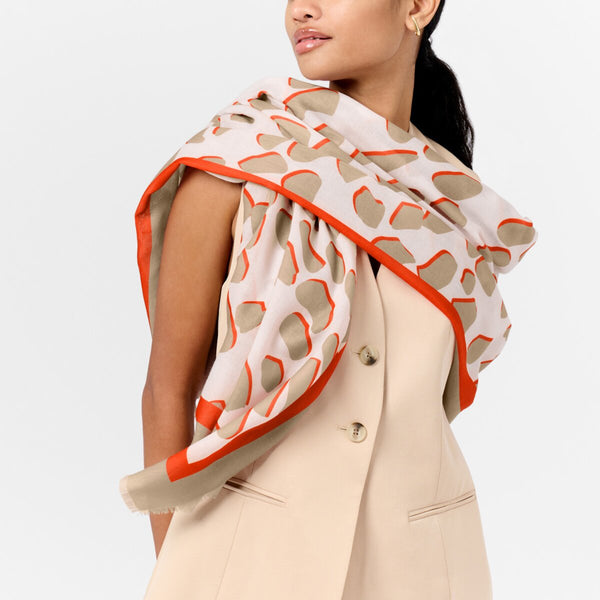 Katie Loxton dalmatian print scarf in ecru and orange with stylish frayed edges.