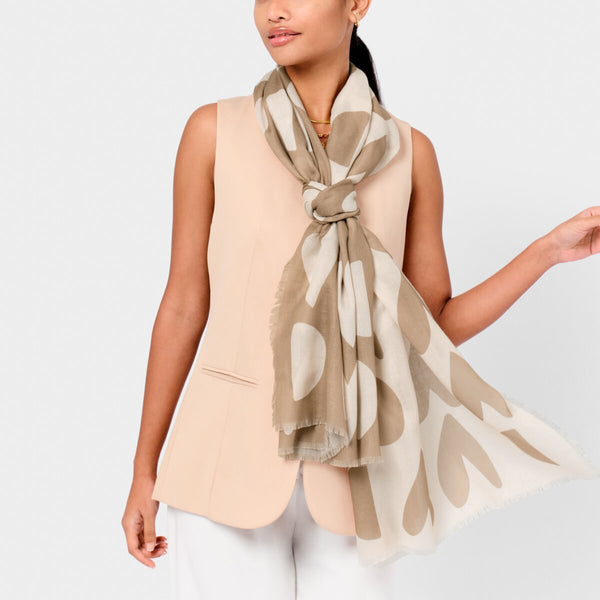 Katie Loxton printed scarf with large heart design in taupe and ecru with a stylish frayed finish.